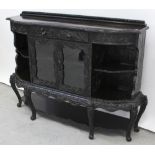 A late Victorian ebonised empire cabinet base with shallow relief and incised floral carving,