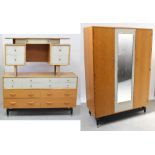 A c1960s G-Plan three-piece bedroom suite comprising pale oak and grey painted wardrobe,
