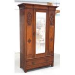 A late 19th century oak Arts and Crafts style single-door wardrobe with incised carved harebell and