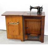 A 1930s foot-cranked Jones sewing machine in original Art Deco red walnut cabinet, height 80cm.