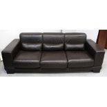 A contemporary Italian brown leather three-seat sofa on block supports, length 226cm.