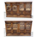A pair of oak floor-standing hall cabinets, each with two sets of twin doors,