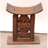 An early 20th century African hardwood stool with elephant decoration.