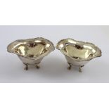 A pair of silver salts, each on four paw supports, marked 'Sterling', combined approx 1.9ozt (2).