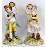 CAPODIMONTE; a pair of 20th century porcelain figures of a boy and a girl with tambourines,