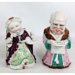 A pair of late 19th century German tobacco jars modelled as lady taking tea and gentleman reading