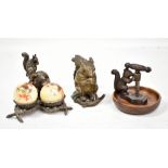A Victorian lidded brass inkwell modelled as a squirrel with a nut, height 10cm, a nutcracker, a