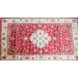 A red ground Keshan carpet, 280 x 200cm.