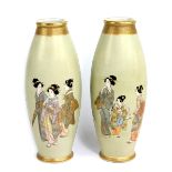 KINKOZAN; a pair of Japanese Satsuma ovoid vases, each decorated with female figures and peasants,