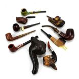 A small collection of pipes including carved meerschaum, ceramic and treen examples.