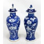 A pair of late 19th/early 20th century Chinese porcelain baluster vases and covers with Dog of Fo