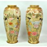 A pair of early 20th century Satsuma baluster vases, each with hand painted and gilt heightened