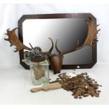 A mixed lot comprising an oak framed bevelled glass mirror, width 84cm, a pair of deer antlers on