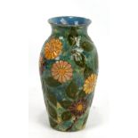 BURMANTOFTS; a turquoise glazed vase with flared rim and incised foliate decoration, impressed marks