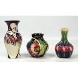 MOORCROFT; three floral tubeline decorated small sized vases of varied form including 'Queen's