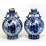 A pair of 19th century Chinese porcelain moon flasks, both painted in underglaze blue with robed