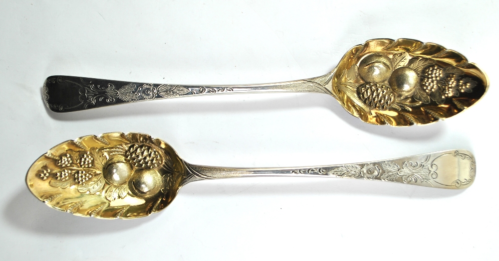 PETER & ANN BATEMAN; a pair of George III hallmarked silver berry spoons with engraved stems and