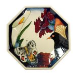 MOORCROFT; a 'Medley' pattern octagonal plate with tubelined decoration of butterfly, bird and