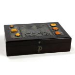 A Polish rectangular box, the lid decorated with metalwork and inset with Polish amber, width 24cm.