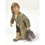 DAHL JENSEN FOR COPENHAGEN; a ceramic figure modelled as a fisher boy carrying his catch, with