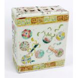 A Chinese porcelain Famille Rose flower brick with bands of Greek key decoration centred by