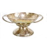 EDWARD SPENCER; an Arts and Crafts hammered silver plated pedestal bowl, with loop handles, band