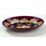 MOORCROFT; a Moorcroft Collectors' Club floral tubeline decorated oval bowl on purple/maroon
