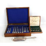 A cased set of twelve electroplated dessert knives and forks (one missing), a crumb scoop, and a