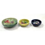 MOORCROFT; three floral tubeline decorated bowls, all with impressed marks to bases, diameter of