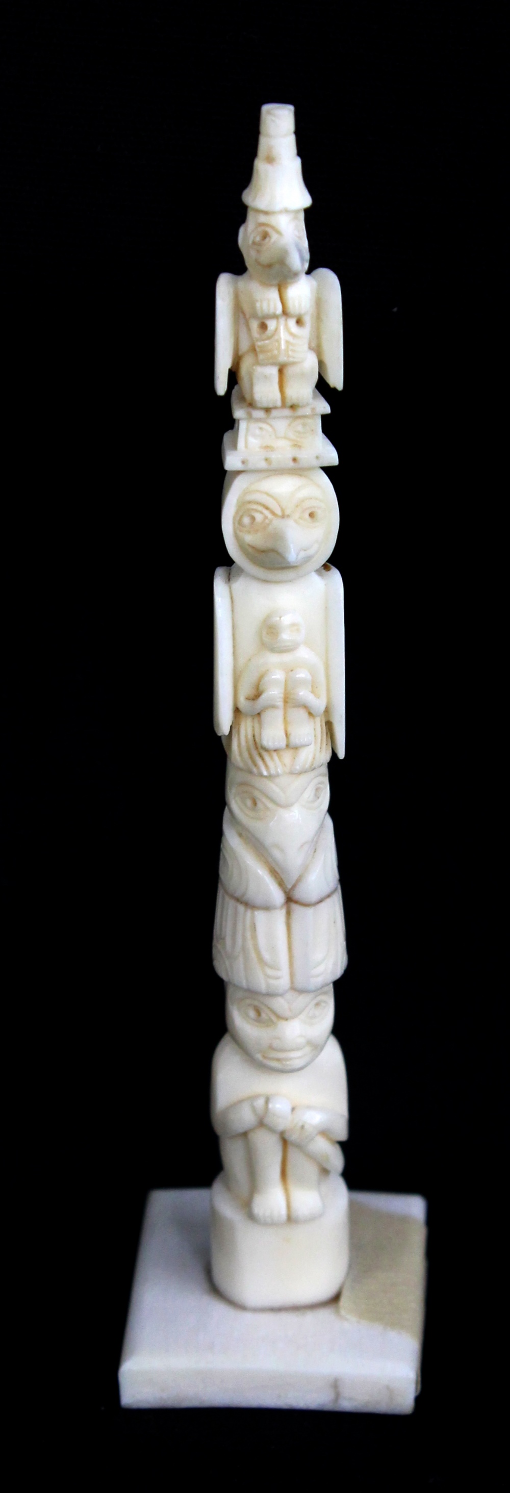 A rare 19th century carved walrus ivory miniature totem pole, purportedly originating from British