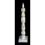 A rare 19th century carved walrus ivory miniature totem pole, purportedly originating from British