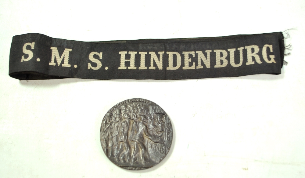 A replica of the 'Lusitania' medal, diameter 5.5cm, boxed, and an S.M.S. Hindenburg black ribbon (