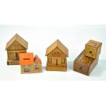 Four wooden moneyboxes comprising two modelled as houses with concealed slots and two further