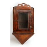 A small 19th century walnut hanging wall cabinet with glazed door and inverted pyramid base,