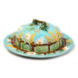 GEORGE JONES; a Victorian majolica butter dish with moulded corn, picket fence and daisy decoration,