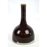 A late 19th century Chinese porcelain dark brown glazed mallet vase with slender neck, bearing