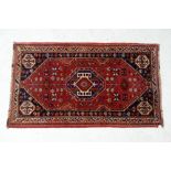 A small Hamadan rug with central device set lozenge shaped medallion within a triple stylised