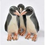 ROYAL COPENHAGEN; a figure group modelled as three penguins with printed and underglaze blue marks