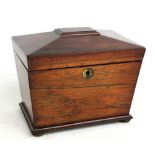A Regency rosewood sarcophagus tea caddy, the hinged lid enclosing two sectioned lidded interior, on
