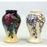 MOORCROFT; two floral tubeline decorated miniature baluster vases, both with impressed marks and