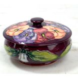 MOORCROFT; a purple ground 'Pansy' pattern tubeline decorated lidded bowl, impressed marks and