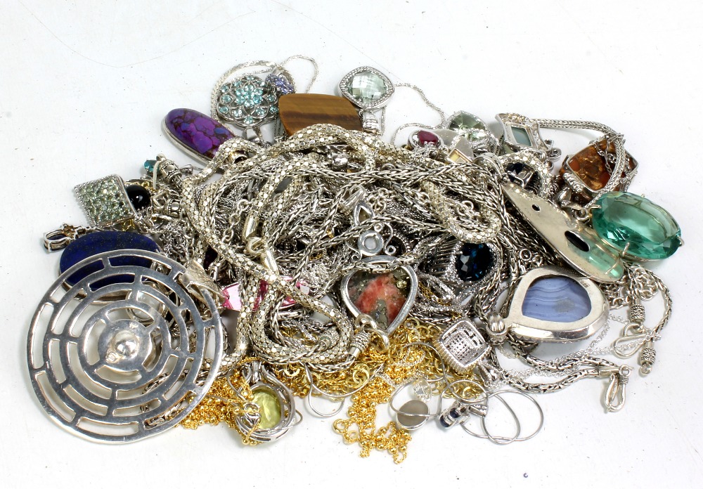 A group of silver pendants on chains.