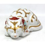 A Japanese porcelain model of a sleeping cat decorated in gilt and enamels, unmarked, length 24cm.