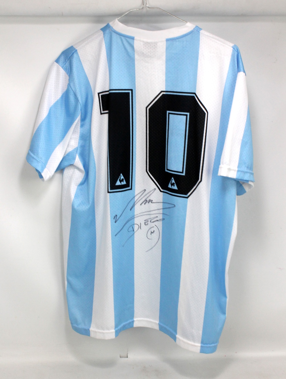 DIEGO MARADONA; a replica Argentina 1986 shirt, signed and number '10' to reverse, size XL.