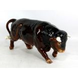 SYLVAC; a large brown glazed model of a buffalo, length 35cm.