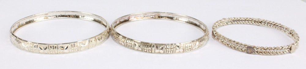 Three Indian white metal bangles.