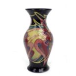 MOORCROFT; a floral tubeline decorated baluster vase with flared rim, impressed marks and year
