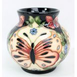 MOORCROFT; a butterfly and floral tubeline decorated vase with impressed marks, Rachel Bishop