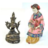 A 20th century Chinese stoneware figure of a girl, impressed and inscribed marks to base, height