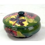 MOORCROFT; a green ground 'Hibiscus' pattern tubeline decorated lidded bowl with impressed marks and